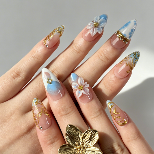 Sky Gilded baby blue cloud almond press on nails worn on hand, gilded swirl floral sweet spring dating nail art