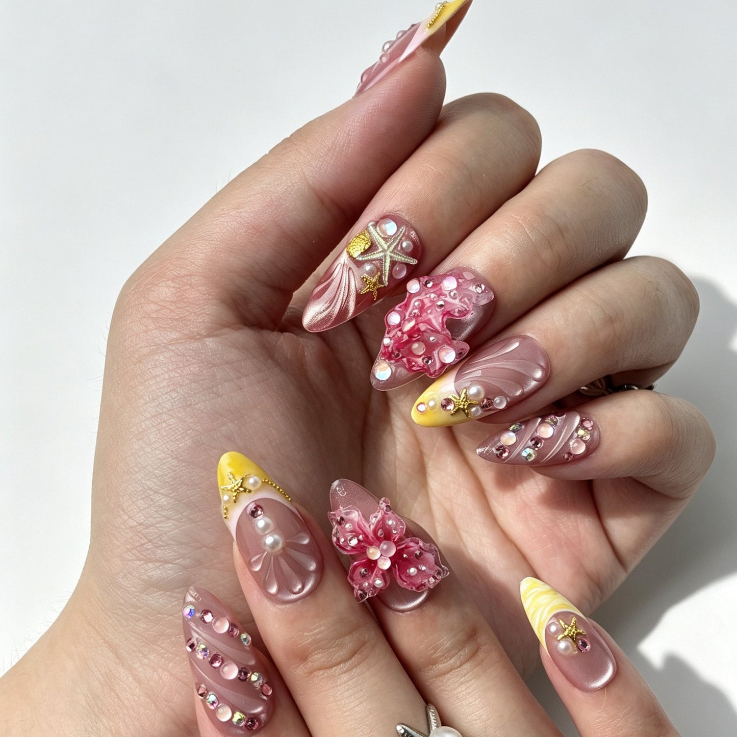 Close hand shot of 3D pearl seashell starfish press on nails mermaid manicure