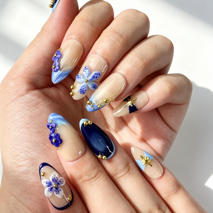 Close Up 3D Embossed Nail Art, Blue Floral Gold Star Bead Decor, Medium Almond Nude Dark Blue Gradient Press On Nail Detail Shot