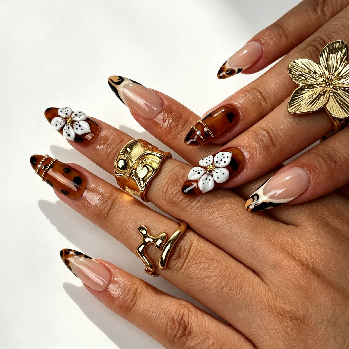 Amber Blaze handmade almond press on nails, bold tortoiseshell tiger French tip nail art on hand