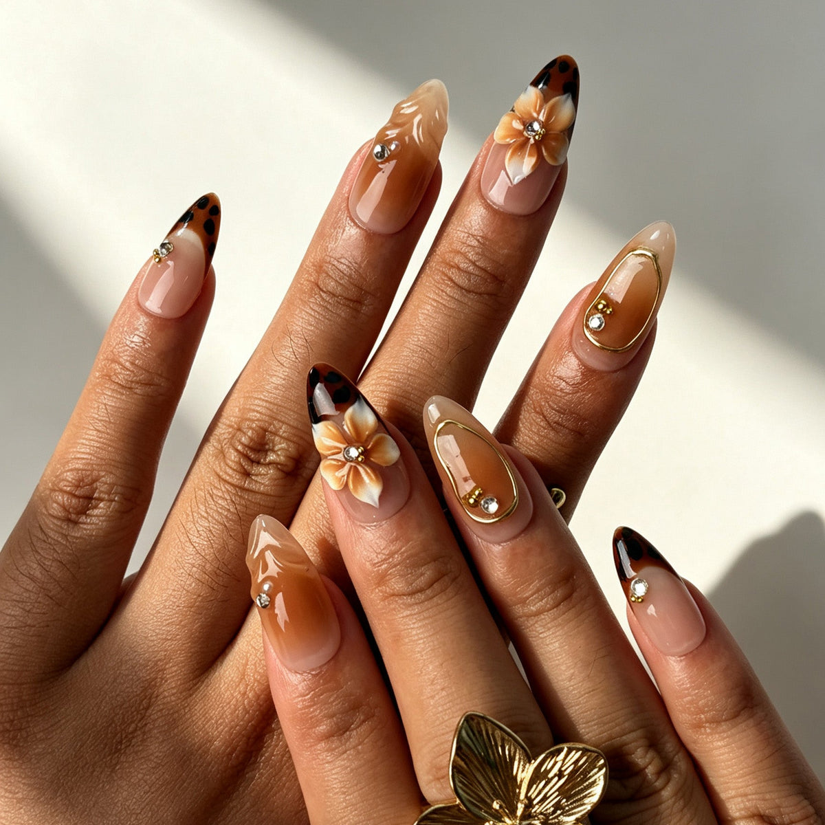 Romantic almond false nails, soft nude pink base, brown flower, white French tip, gold frame and 3D gradient flower
