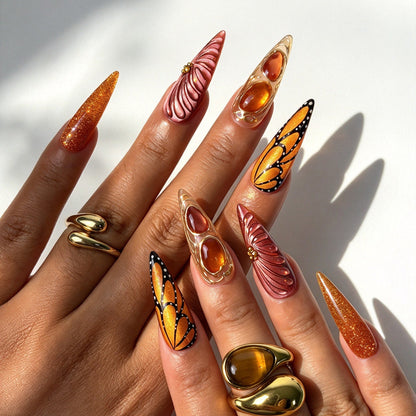 Long stiletto false nails, warm fall orange butterfly 3D swirl and feather relief nail design
