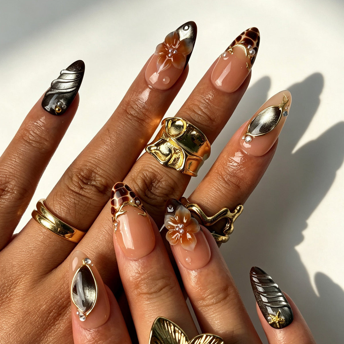 Seaside retro almond false nails, nude pink base, brown cat-eye, 3D shell, gold star, oval gem and pearl flower