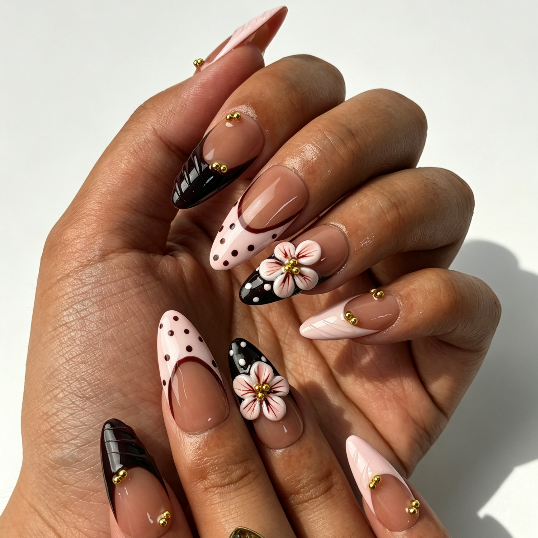 Blush Wine romantic medium almond false nails close-up, nude blush gradient, translucent flower and gold bead manicure