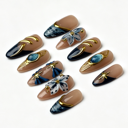 Jade Filigree salon-grade almond nail set, nude gradient aqua cat eye, sculpted blue flowers, gold star and hollow metal filigree details