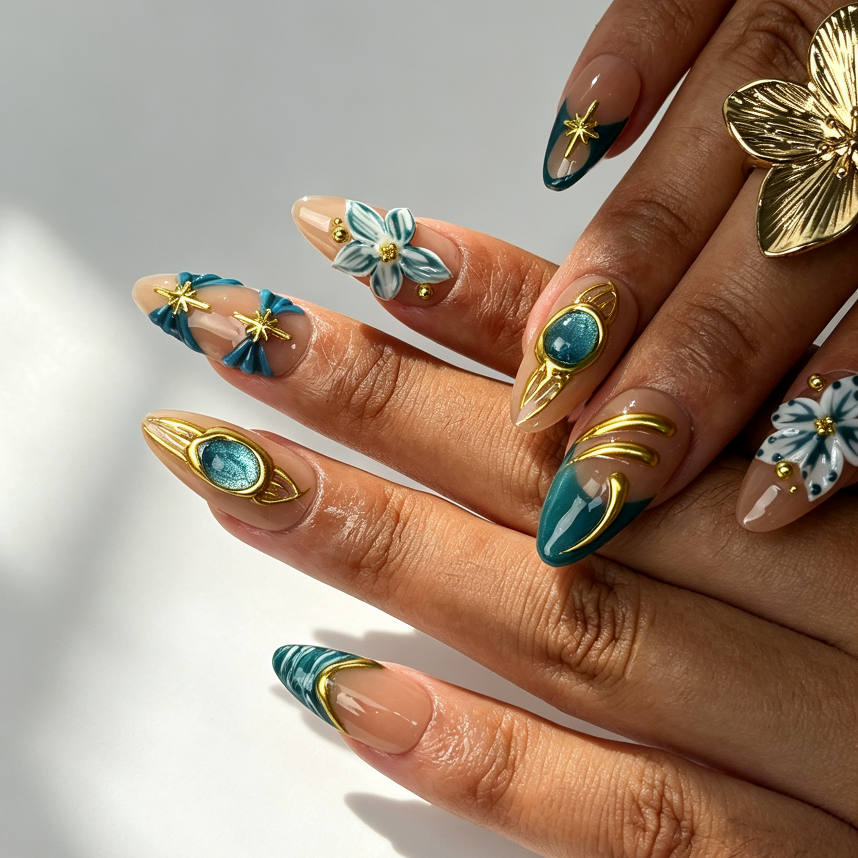 Jade Filigree luxury press on nails on fingers, aqua cat eye gradient, golden star frame and hand-painted blue flower manicure