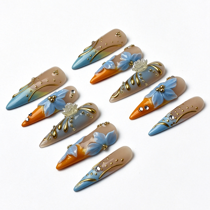 Citrus Aqua salon-grade long stiletto nail set, summer citrus gradient with 3D light blue floral and golden swirl accents