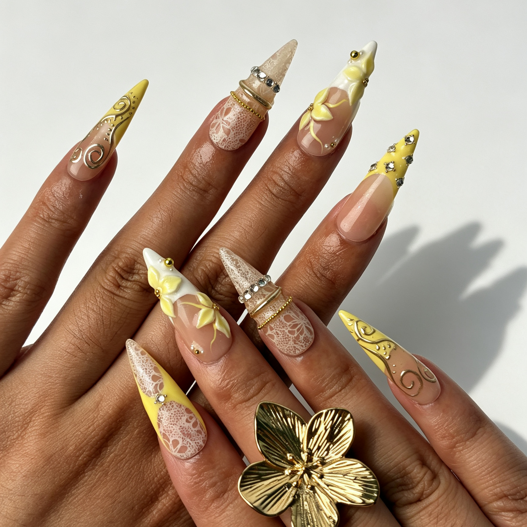 Lemon Lace pastel yellow stiletto false nails close-up, sheer lace texture, 3D yellow floral and silver rhinestone romantic manicure