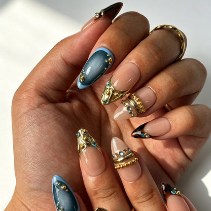 Handmade blue‑grey cat‑eye press‑on nails with leopard French and gold metal decor