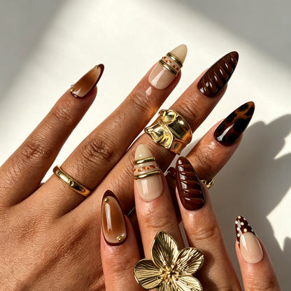 Retro maillard almond false nails, nude beige base, tortoiseshell marbling, chocolate French tip and gold bands