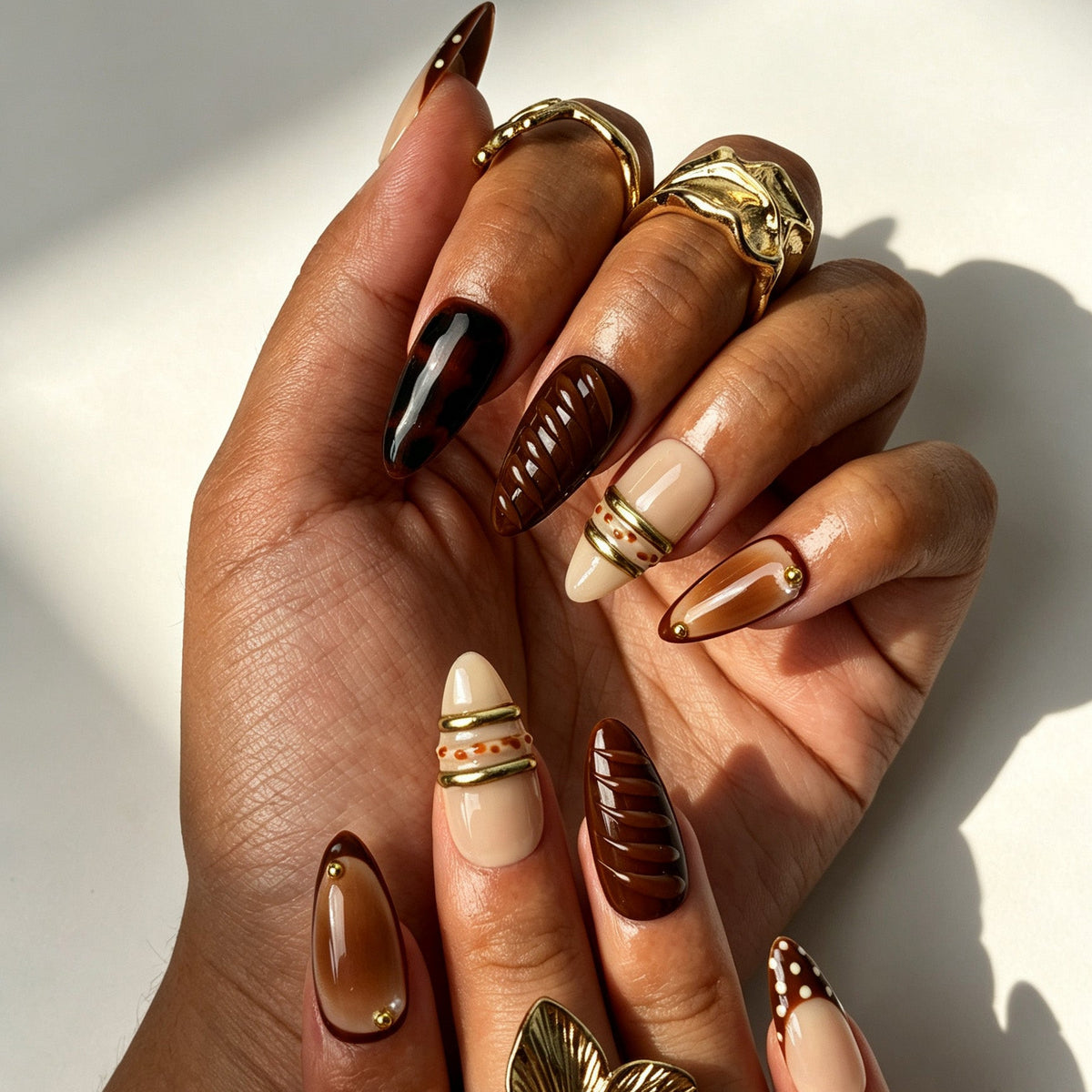 Handcrafted almond press on nails, chocolate French tip tortoiseshell design for autumn styling and dates