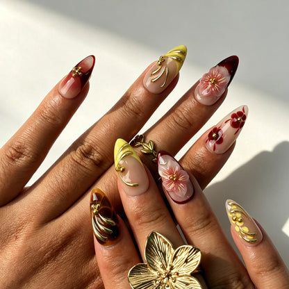Handmade wine red ombre press‑on nails with 3D pink sakura and gold metal swirl details
