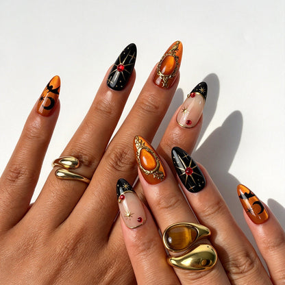 Gothic almond false nails, orange black Halloween design with butterfly print, gold studs and red rhinestones