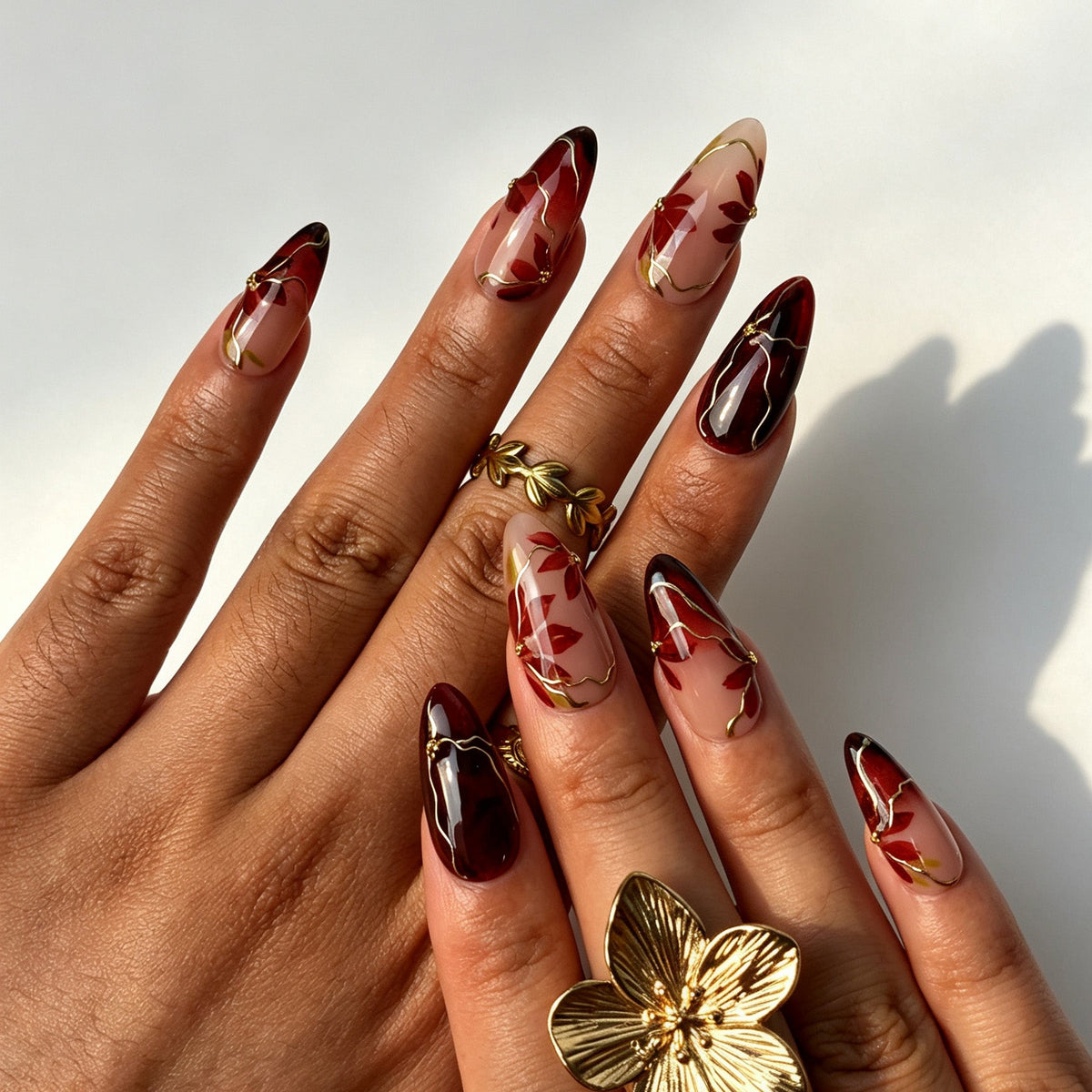 Vintage almond false nails, sheer nude base, wine red-black ombre, hand-painted maple leaf and gold wire