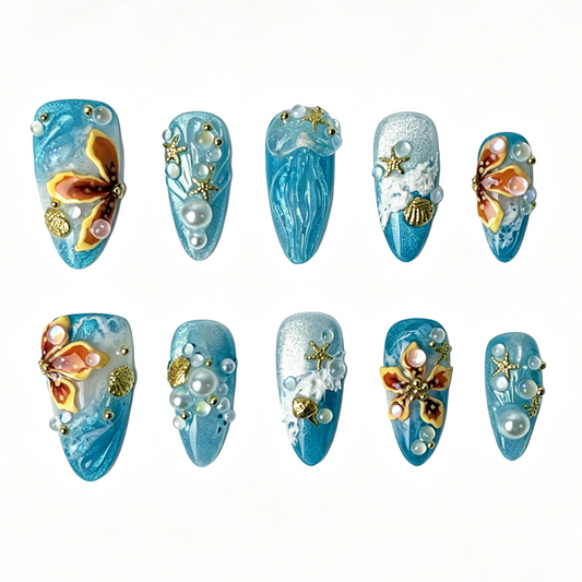 Turquoise Mermaid Bay medium almond press on nails, teal cat eye ocean design with 3D jellyfish, butterfly, starfish, shell and pearl embellishments