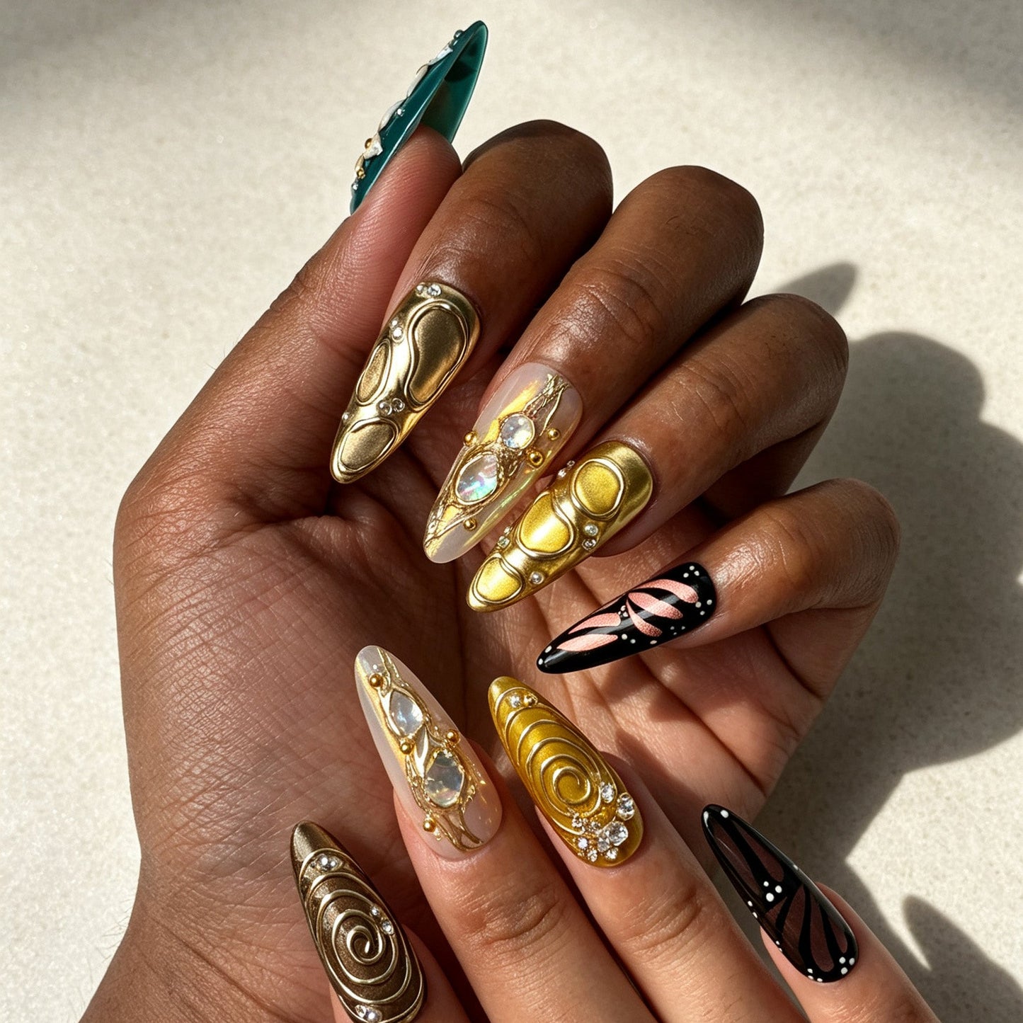 Close‑up handmade press‑on nails, sculpted 3D flower metallic‑gold‑swirl iridescent shell inlay manicure