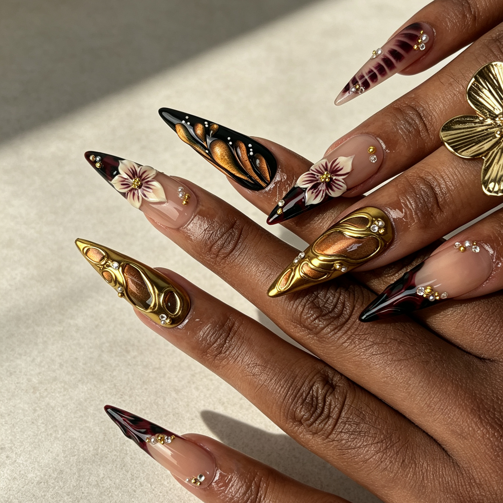 Close-up handmade stiletto nails hand-painted 3D flower gold bead pearl rhinestone decoration