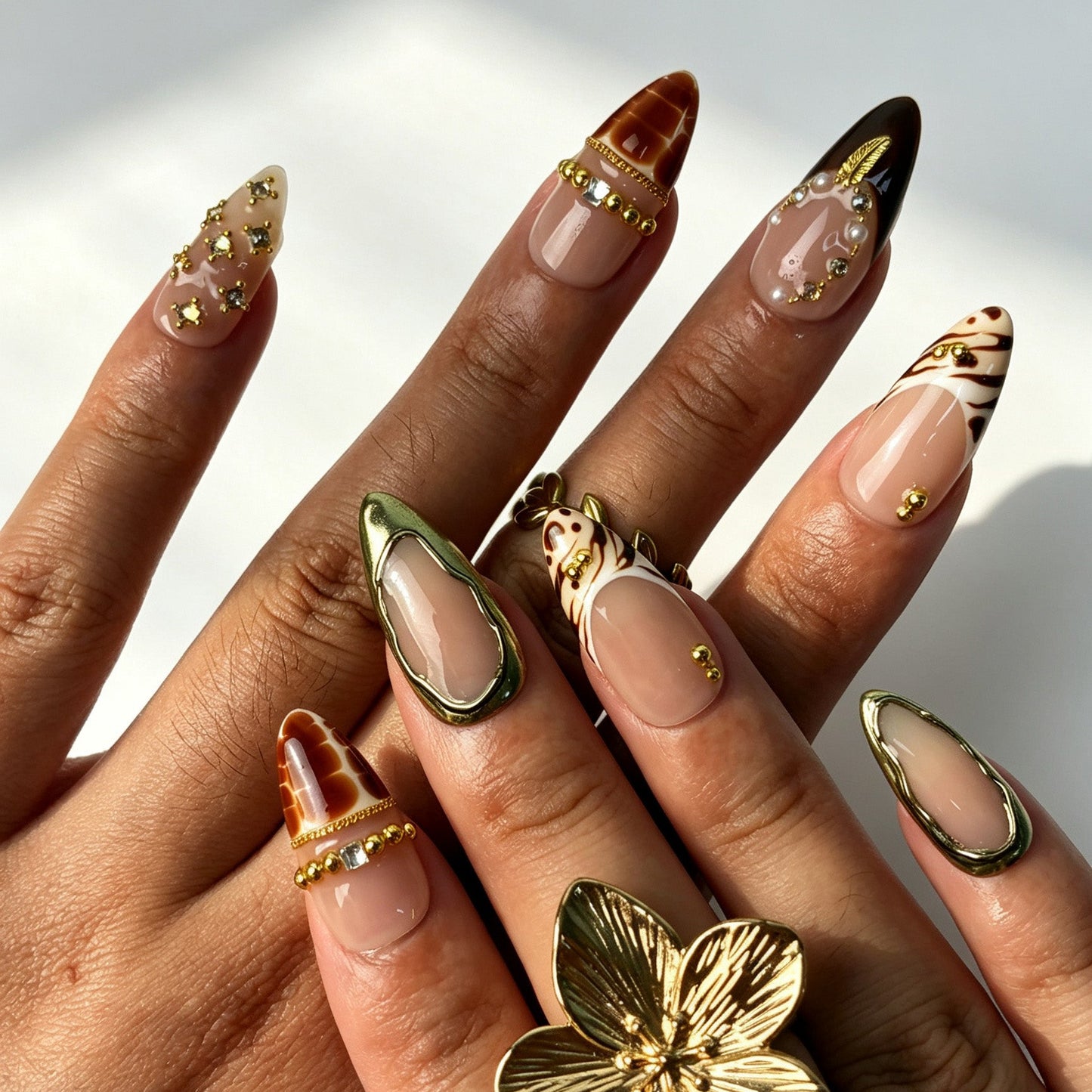 Handmade vintage tortoiseshell press‑on nails with gold‑leaf charm and pearl details