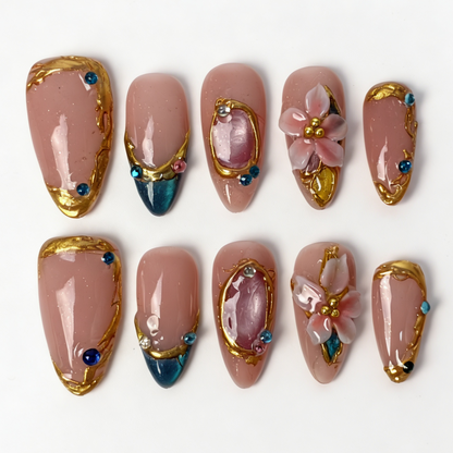 Teal Gilded medium almond press on nails, nude jade teal cat eye french tip, gilded frame, translucent pink flower and mixed rhinestone decor