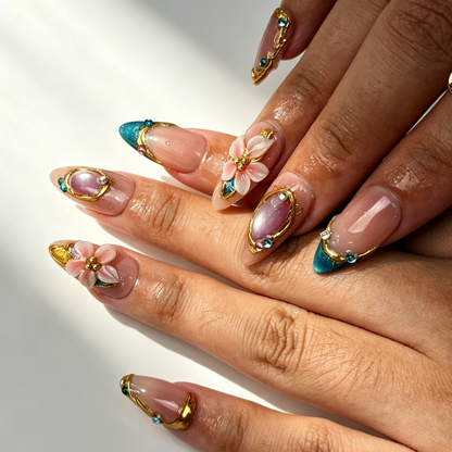 Teal Gilded elegant medium almond false nails close-up, nude teal cat eye french tip with pink flower and rhinestone nail art