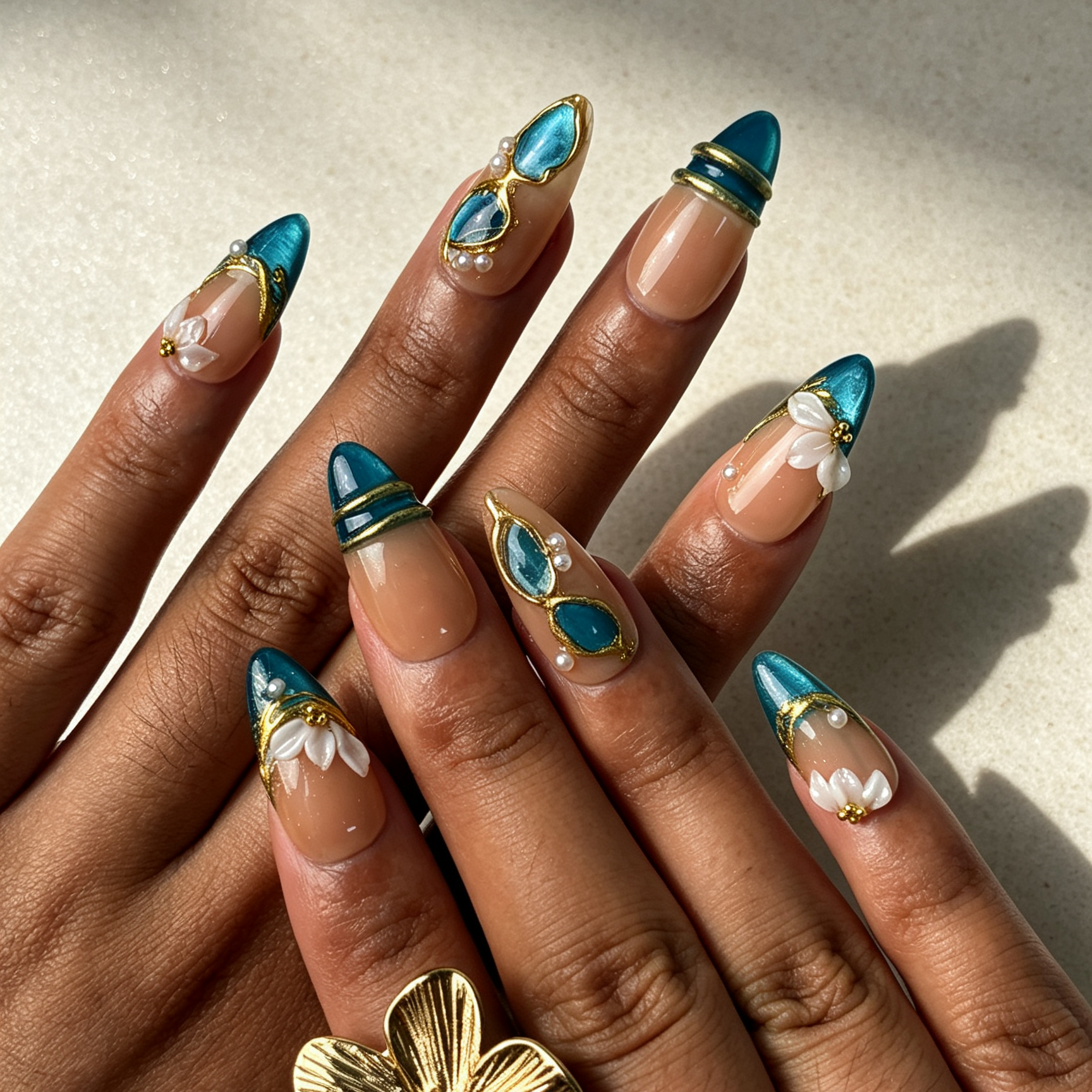 Teal Petal teal cat eye medium almond press on nails worn on hand, gilded white flower elegant oriental office nail art