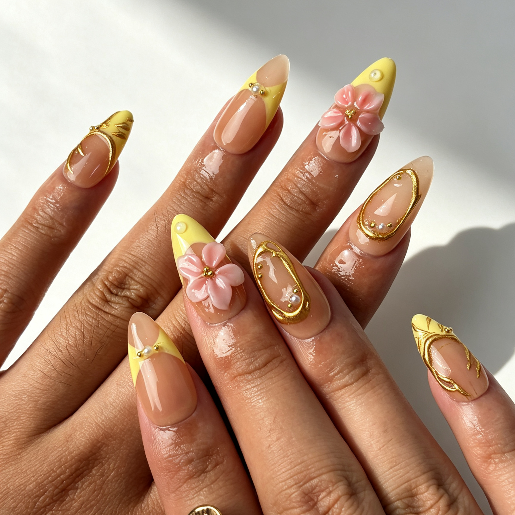 Butter Filigree romantic medium almond false nails close-up, butter yellow french tip floral pearl daily manicure