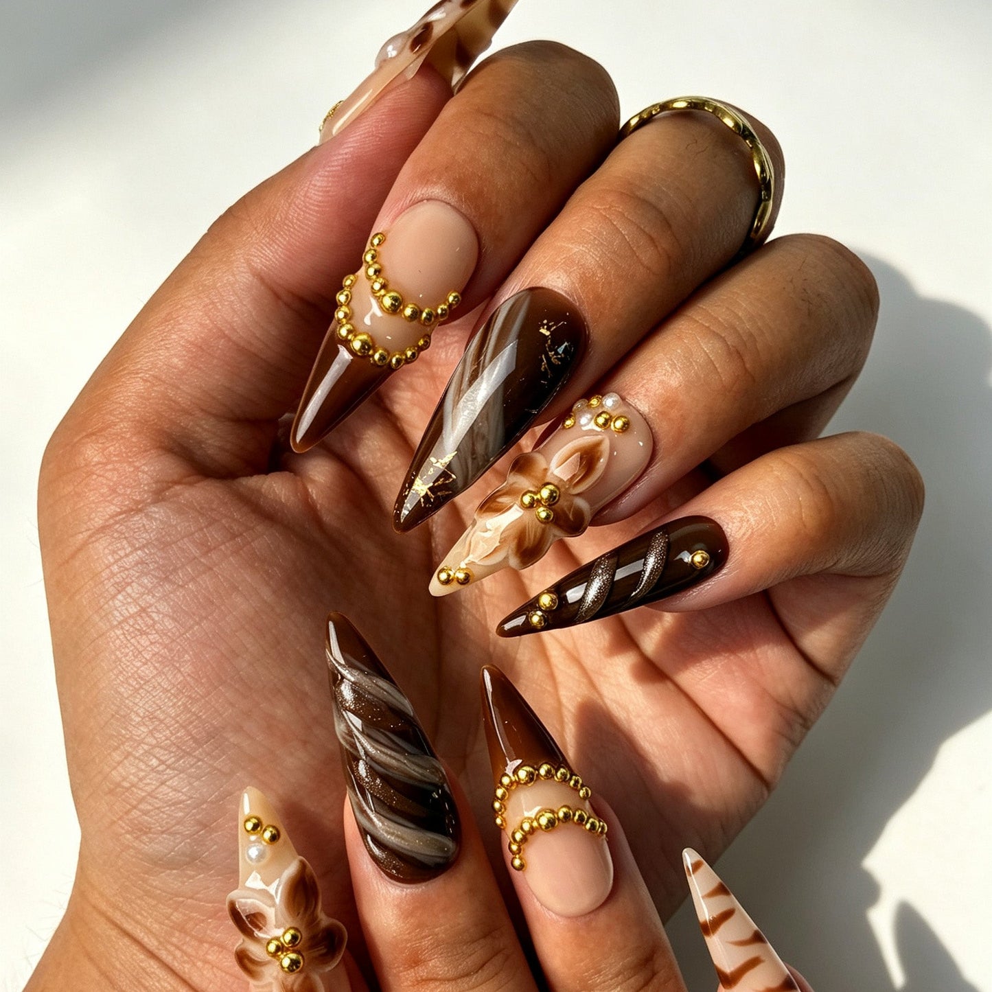 Mocha Bloom autumn press‑on nails on hands, nude coffee brown marble with 3D flower and gold bead chain details