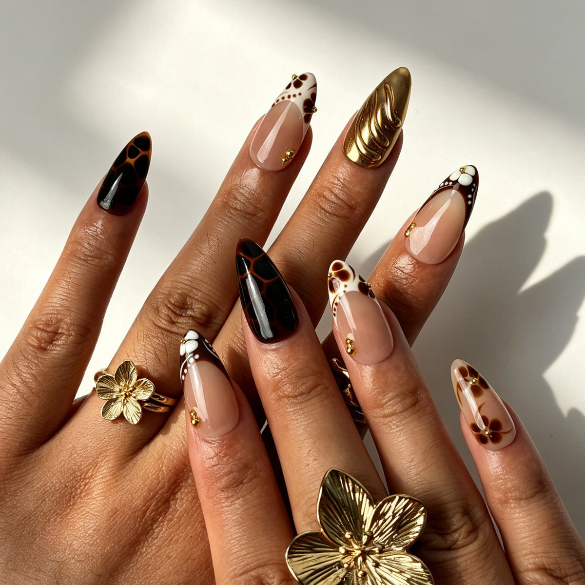 Vintage almond false nails, soft nude pink base, brown flower, white French tip, gold swirl and tortoiseshell giraffe print
