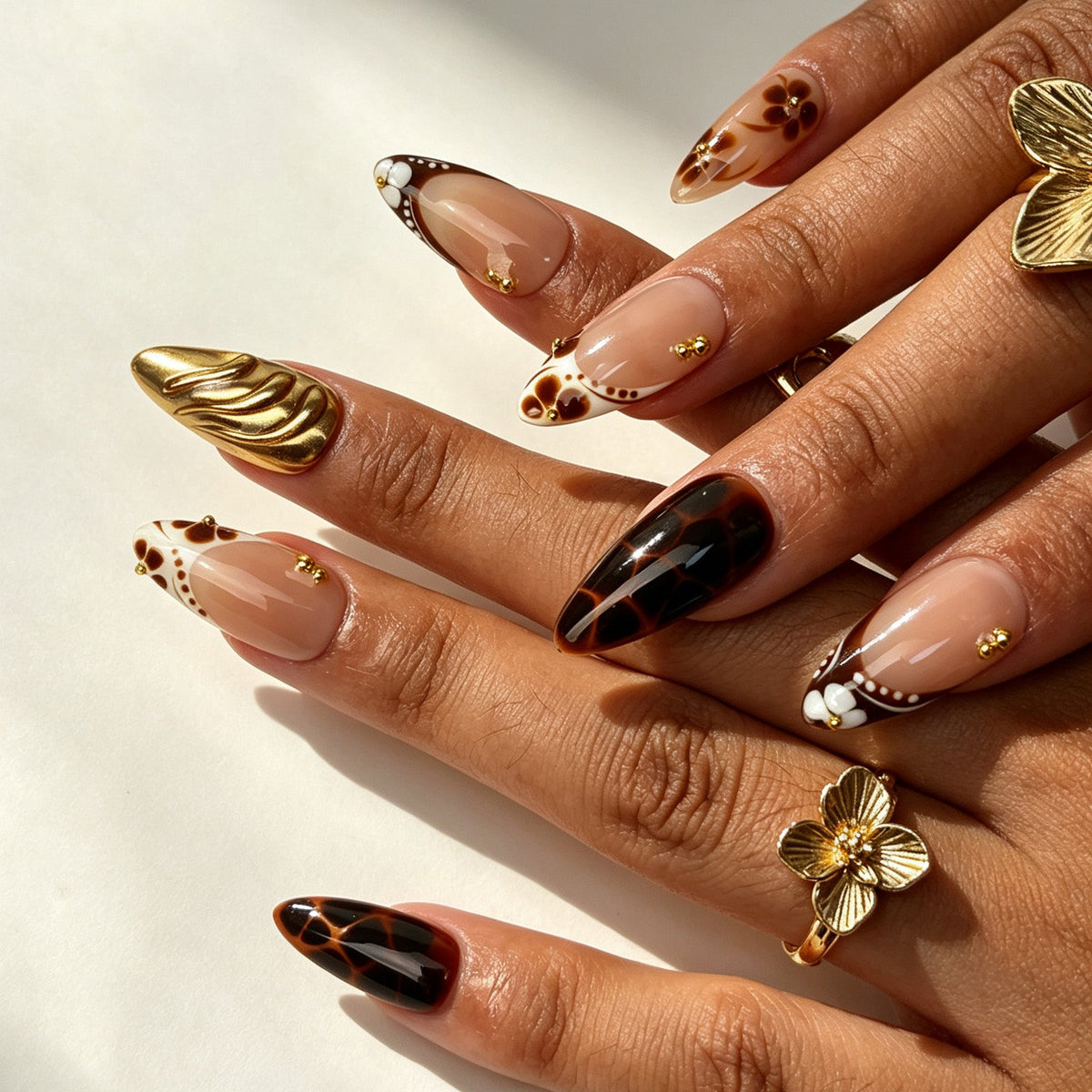 Mocha Blossom handmade almond press on nails, warm maillard brown flower tortoiseshell nail art on hand