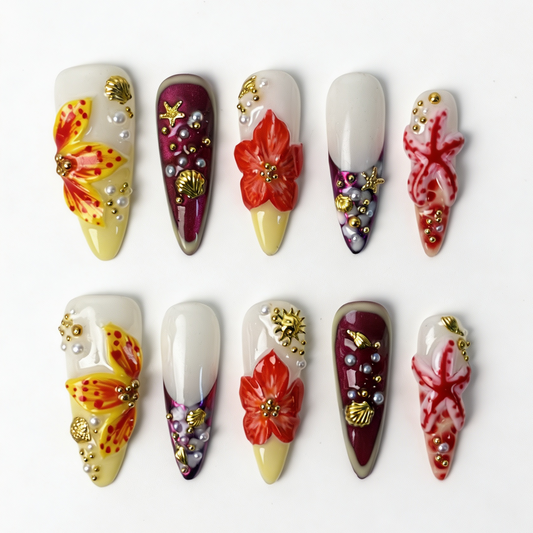 Coral Tide long stiletto press on nails, milky white coral red gradient with tropical flower, golden seashell, starfish and layered pearl decor
