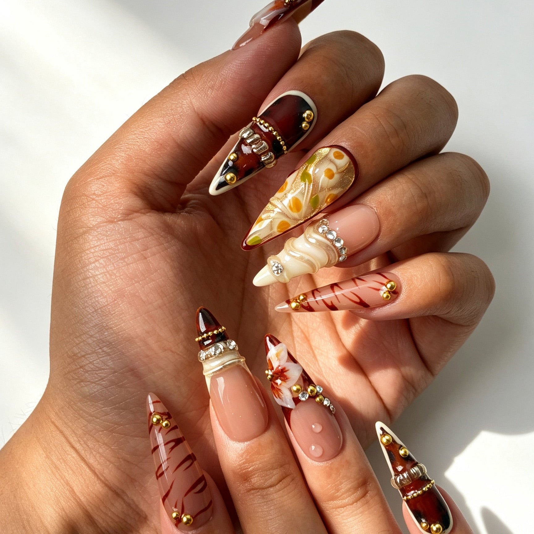 Close‑up handmade press‑on nails, 3D floral art metal texture gold bead manicure