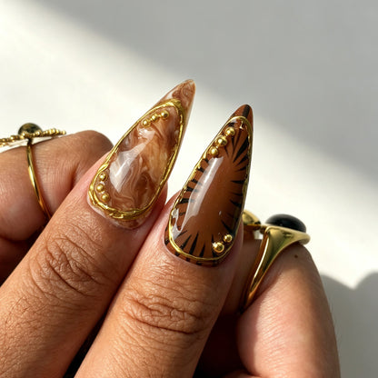 Glossy Gilded Jungle stiletto press‑on nails for date night look