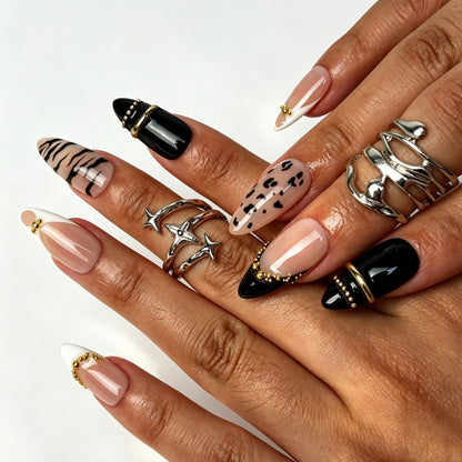 Noir Safari handmade almond press on nails, bold French tip zebra leopard nail art on hand