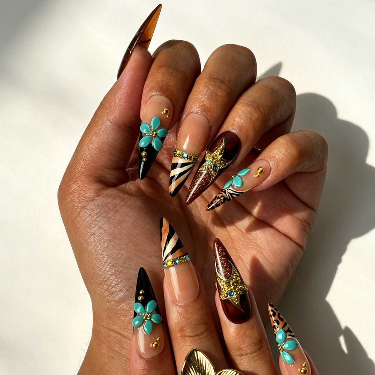 Bold retro stiletto press‑on nails with gold metal stripes & rhinestones on fingernails