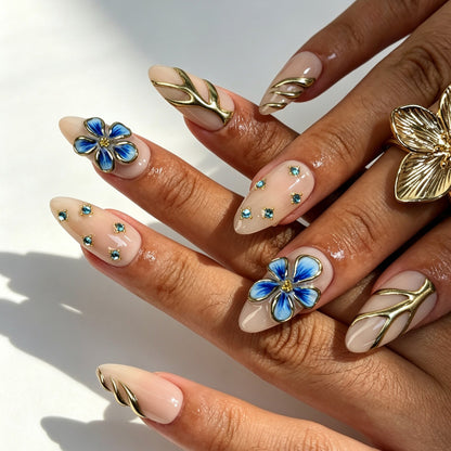 Elegant porcelain‑style almond press‑on nails, blue zebra print nail set with gold branch decor