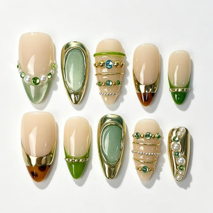 Sage Gilded medium almond press on nails, creamy nude sage metallic green, thick gold framing, layered pearl and green rhinestone decor