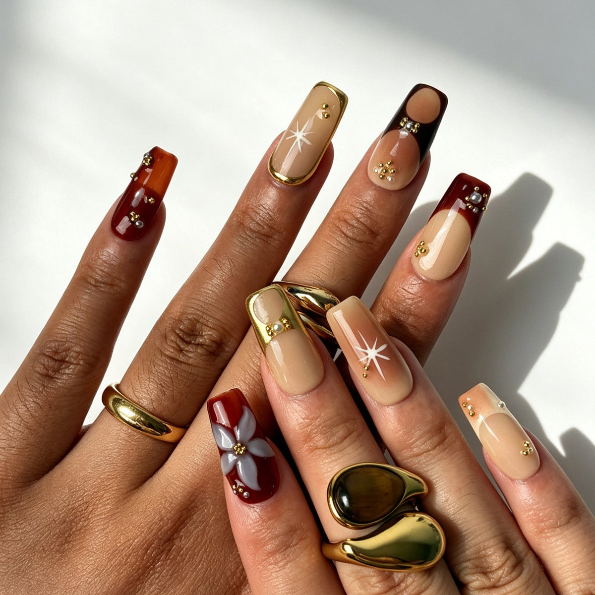 Elegant square false nails, nude burgundy ombre, gold bead, pearl ornament, starburst and 3D flower