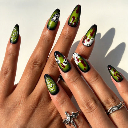 Closeup of hand with neon green ghost skeleton reusable false nails