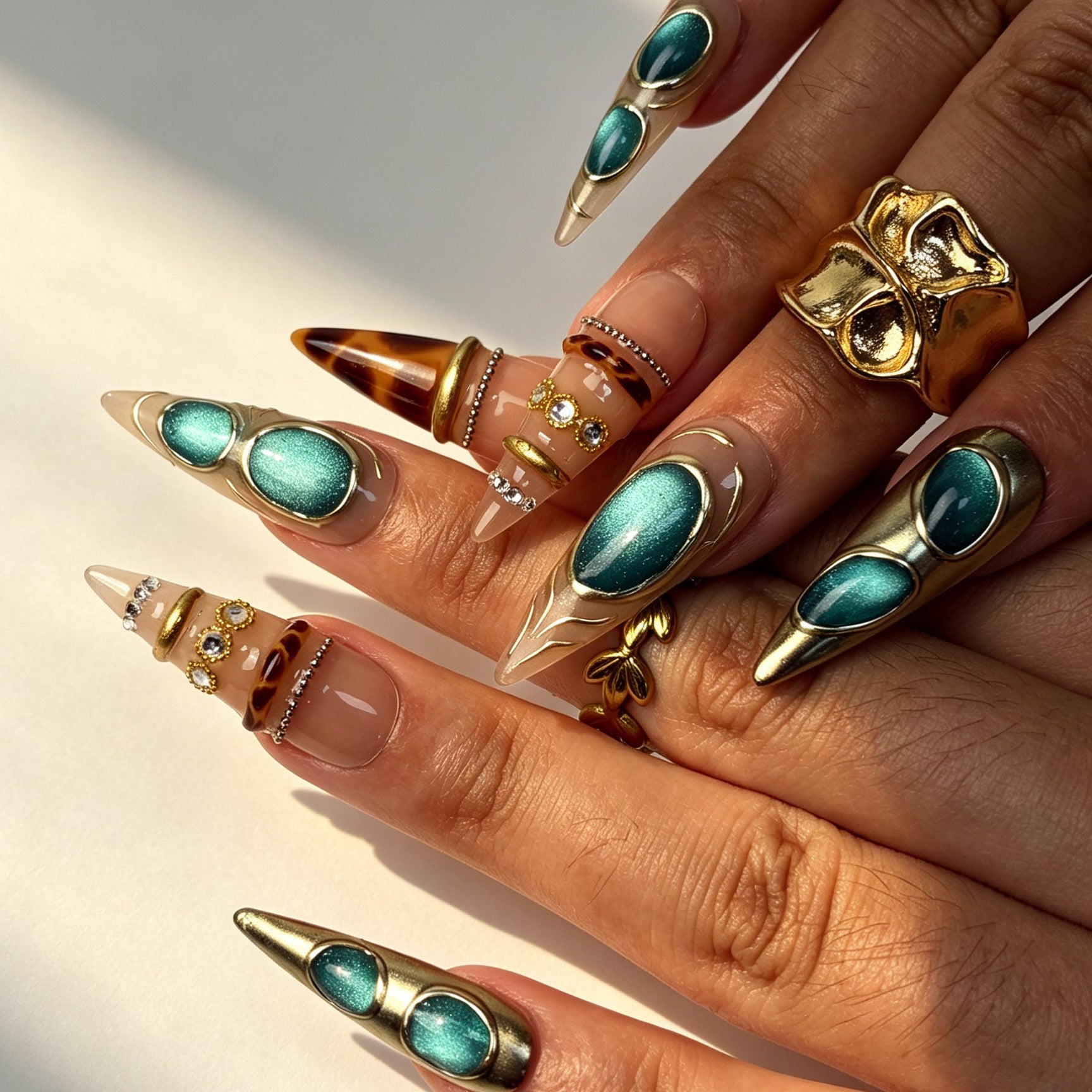 Hand wearing Turquoise Relic vintage gold‑framed turquoise press‑on stiletto nails