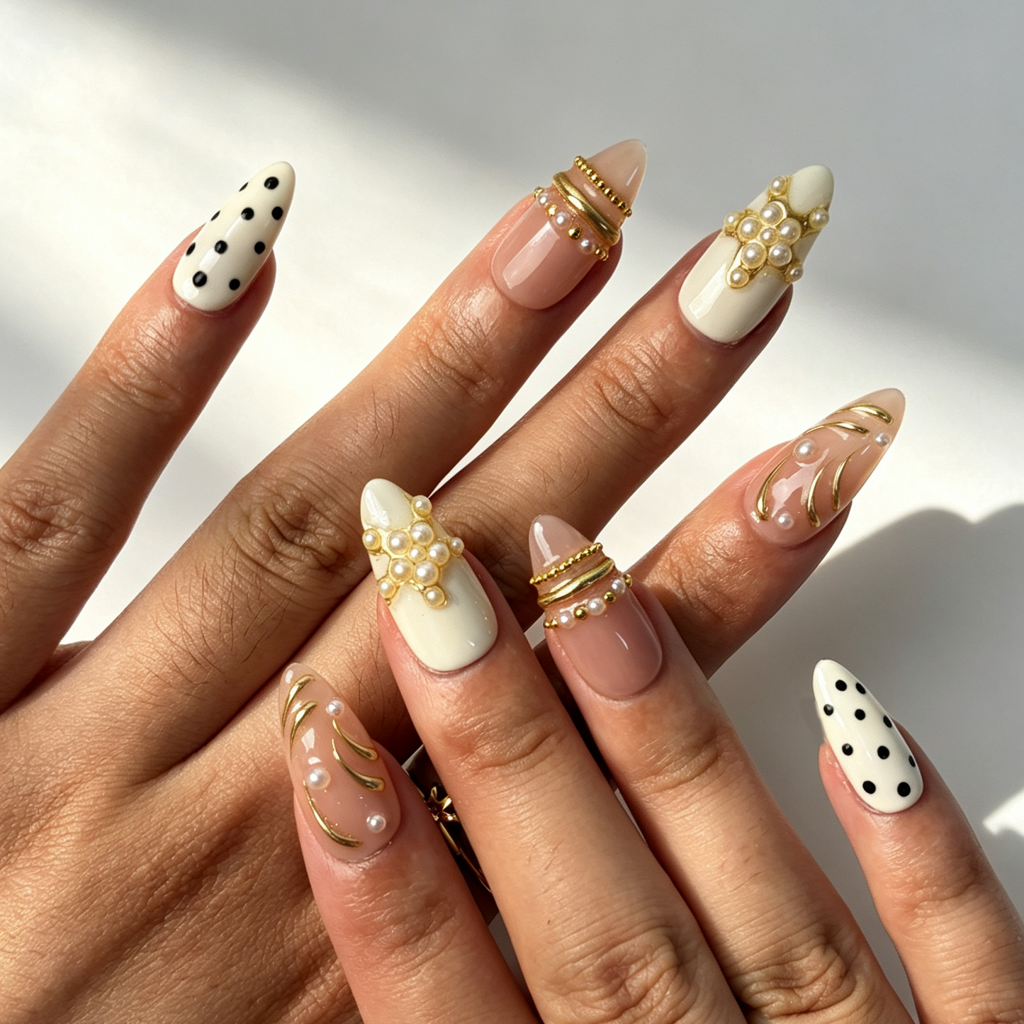 Blush Dot romantic medium almond false nails close-up, dual-tone nude polka dot pearl daily manicure