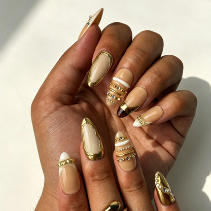 Closeup handmade press on nails stacked pearl crystal rhinestone chain matte gold wrap decoration
