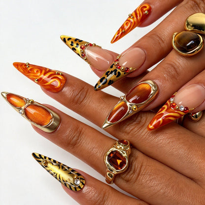 Wild Amber stiletto press on nails, safari tiger print orange flame nail art on hand