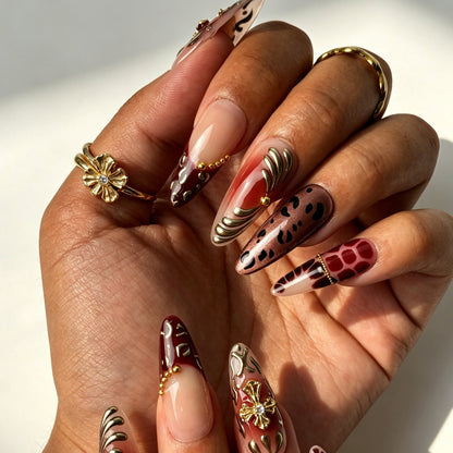 Wine Felis bold vintage press‑on nails close‑up, wine red tortoiseshell 3D gold cross decorations